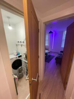 Bright hallway with wood-effect flooring and mo...