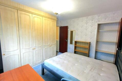 Bright, well-equipped bedroom featuring extensi...