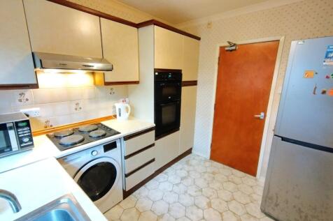 Compact fitted kitchen with integrated applianc...