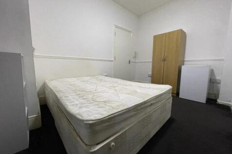 Simple, clean single bedroom with a double matt...