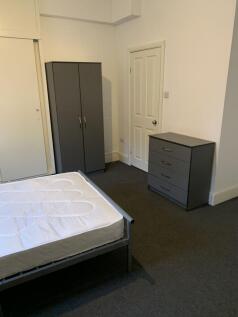 Bright, simply furnished double bedroom with a ...