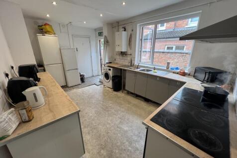 Long communal kitchen with two long worktops, m...