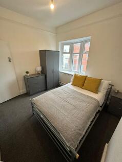 Bright, neatly presented bedroom with a comfort...