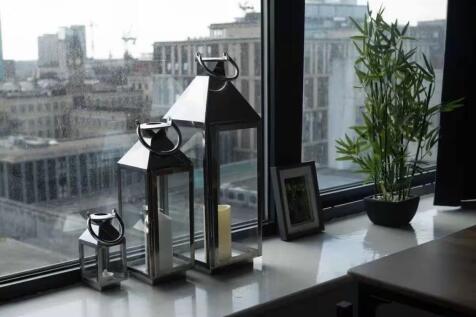 Bright city-view window with decorative lantern...