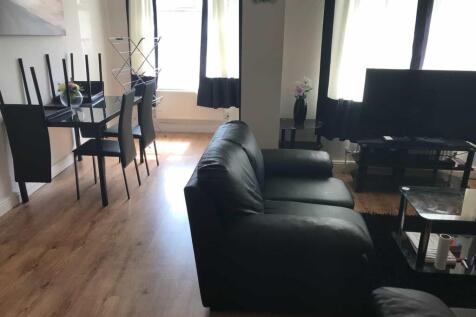 A spacious and modern living room with large wi...