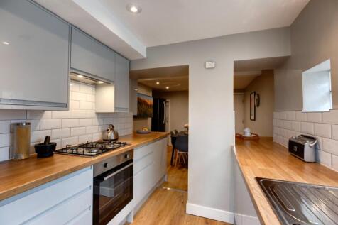 Contemporary galley kitchen with wood-effect wo...