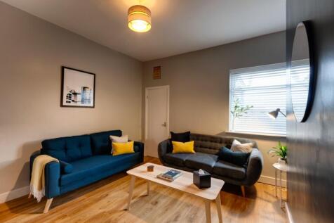 Bright, modern living room with two comfortable...