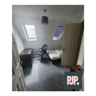 Cozy double bedroom featuring a comfortable bed...