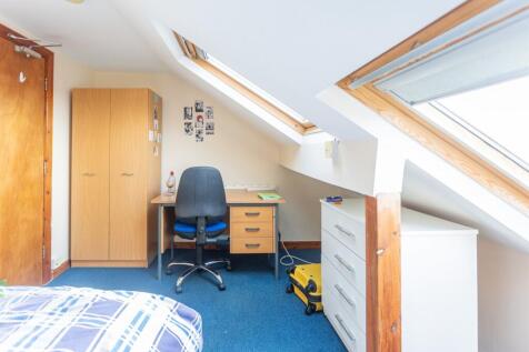 A cozy double bedroom featuring ample natural l...