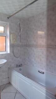 A well-maintained bathroom featuring a spacious...