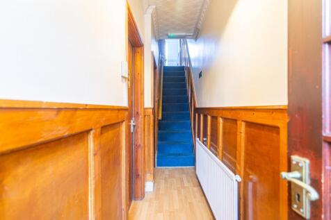Welcoming hallway featuring beautiful wood pane...