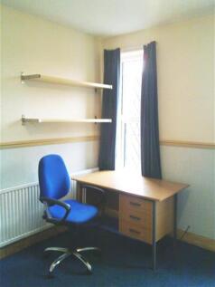Bright and inviting communal workspace featurin...