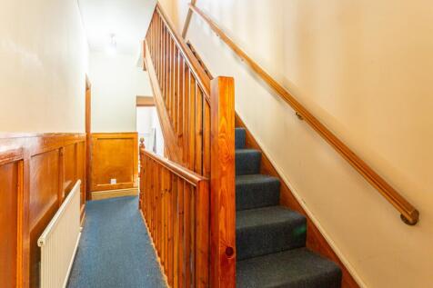 A well-maintained staircase with natural wood a...