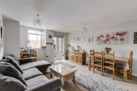 Spacious and inviting living room featuring lar...