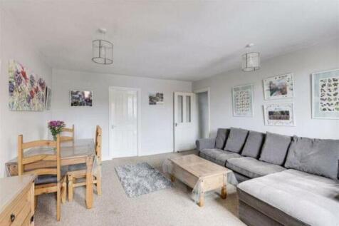 A bright and inviting living room featuring a c...