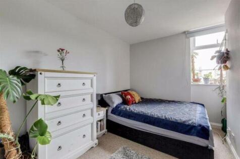This inviting double bedroom features a cozy am...