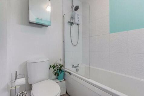 This bright and modern bathroom features a styl...