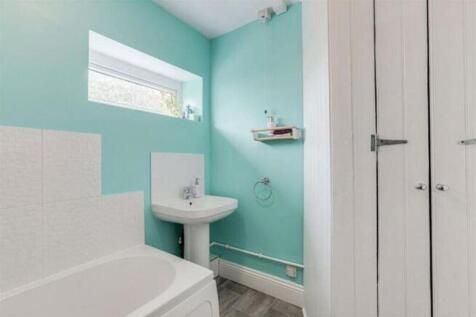 Bright and inviting bathroom featuring a stylis...