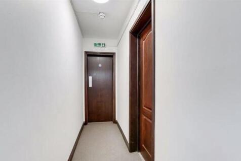 Bright and welcoming hallway leading to private...
