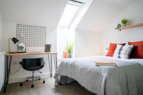 A bright and inviting double bedroom with a sty...