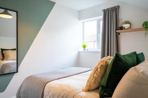 A stylish and inviting double bedroom with ampl...
