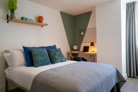 A stylish and well-lit double bedroom with mode...