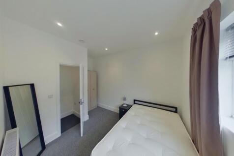 A bright and inviting double bedroom with moder...