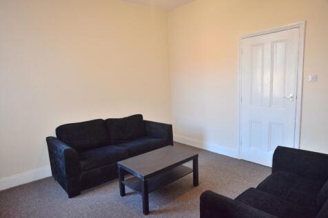 A cozy living room featuring comfortable sofas,...