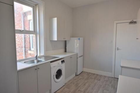 Bright and modern kitchen featuring ample stora...