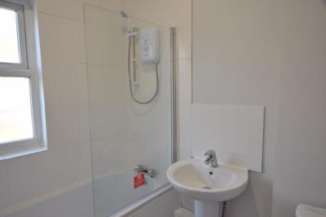 A well-maintained bathroom featuring a shower a...