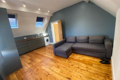 A spacious and stylish modern living room featu...