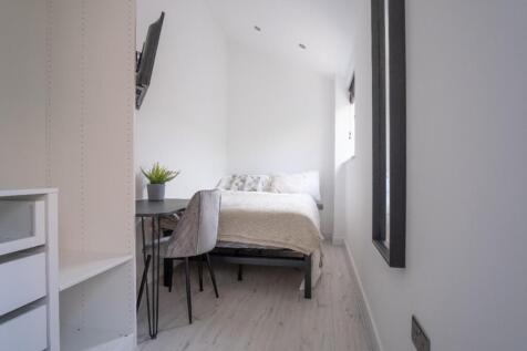 Cozy double bedroom featuring a comfortable bed...