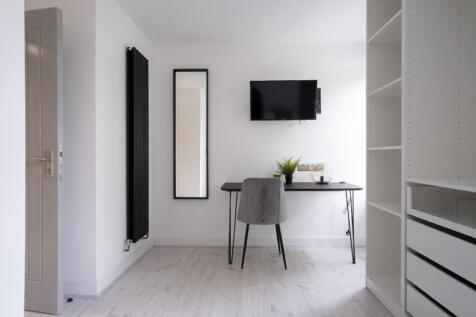 This stylish communal workspace offers a modern...