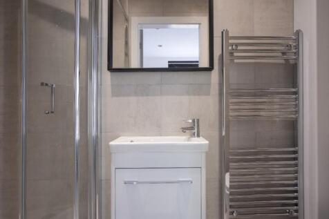 A modern bathroom featuring a sleek shower, sty...