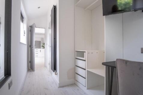 A bright and tidy hallway featuring contemporar...