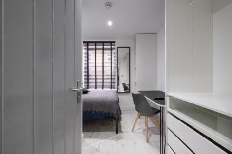 A cozy double bedroom featuring modern furnishi...