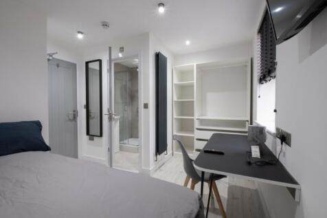 This stylish double bedroom features a comforta...