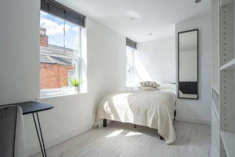 This charming double bedroom features large win...