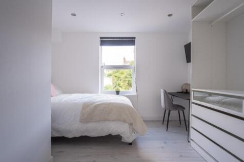 A bright and inviting double bedroom featuring ...