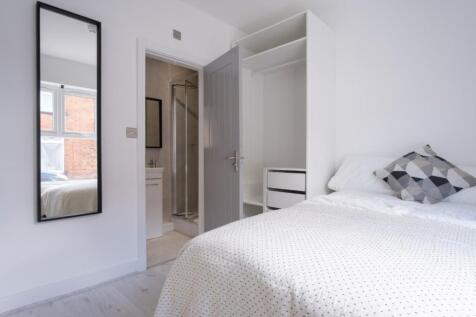 This inviting double bedroom features a comfort...