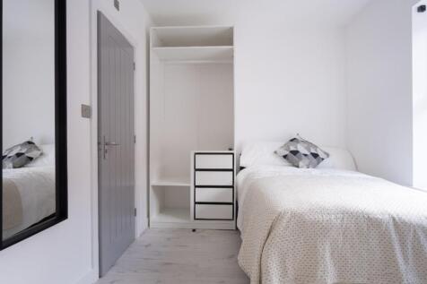 Cozy double bedroom featuring a comfortable bed...