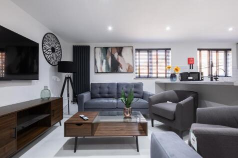 A stylish living room featuring contemporary fu...