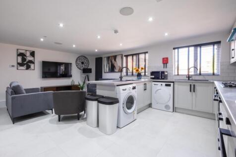 Bright and modern kitchen featuring ample count...