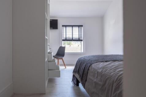 This cozy double bedroom features a comfortable...