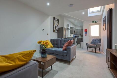 Spacious and inviting living room featuring mod...