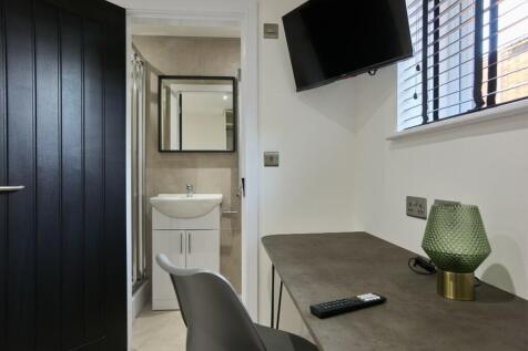 A modern bathroom featuring sleek fixtures, amp...