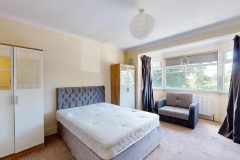 A bright and welcoming master bedroom featuring...