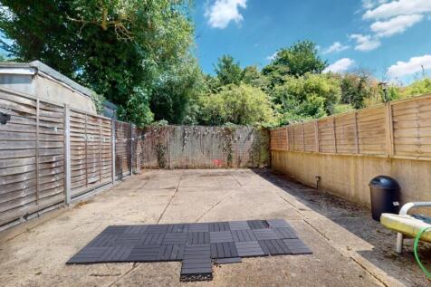 A spacious, well-maintained garden area with fe...