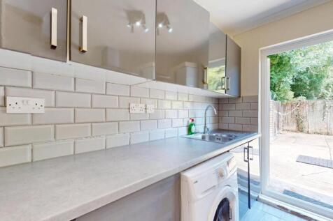 Bright and clean kitchen featuring modern white...