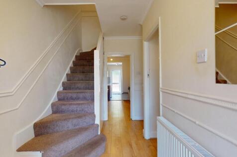 Bright and welcoming hallway featuring clean wo...